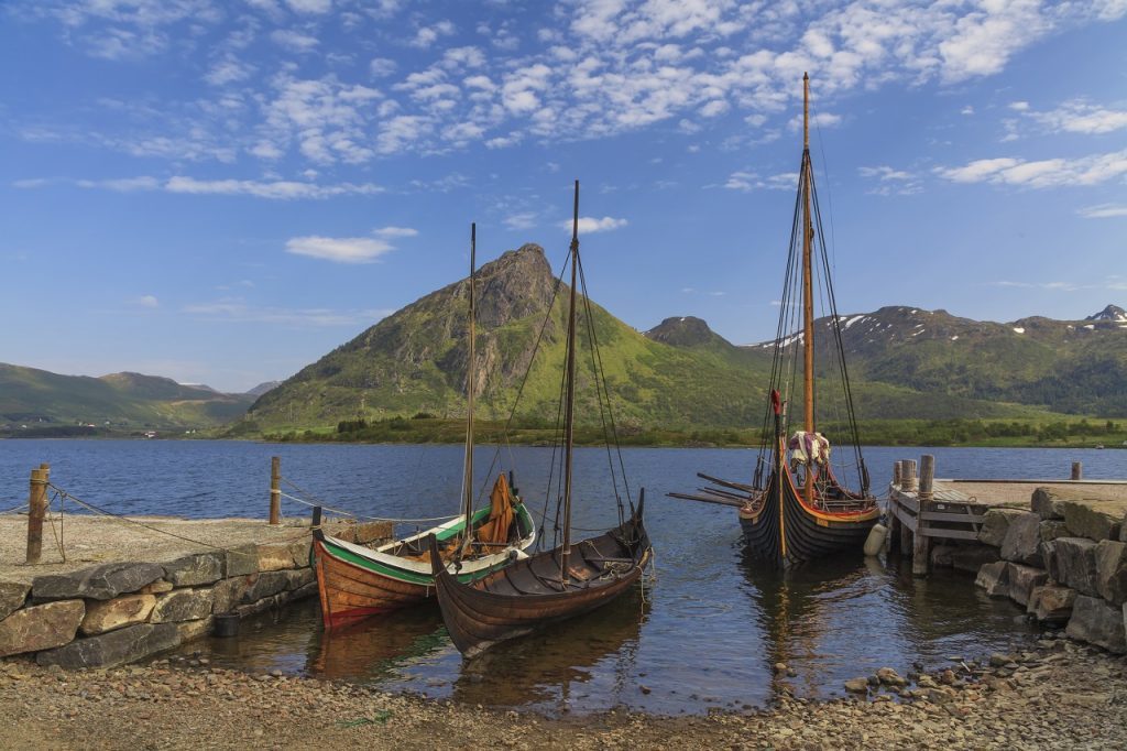 Mountains and fjord Sognefjord in Norway, Scandinavia. Old viking boat on seashore.