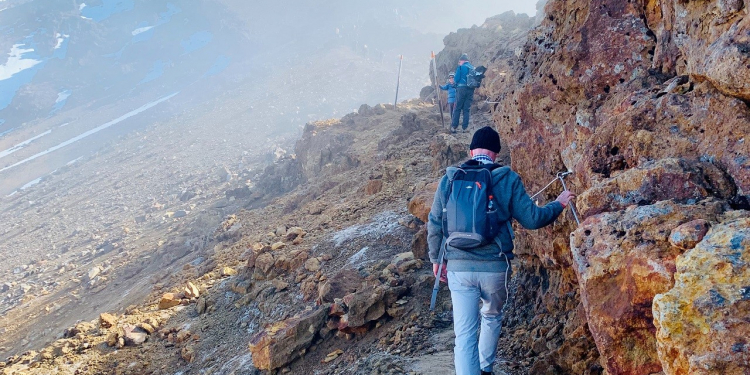 A hiker walks towards Mt. Ngauruhoe (Mt. Doom in the Lord of the