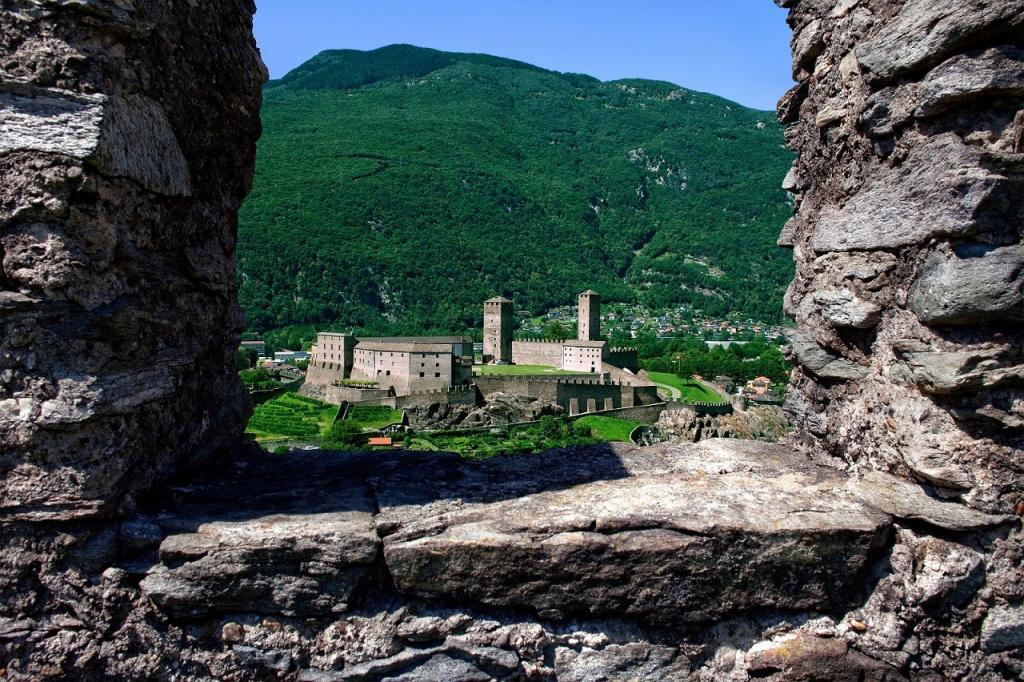 Castlegrande framed by ruined stone of Montebello Castle, Three Castles of Bellinzona, Ticino, Switzerland.