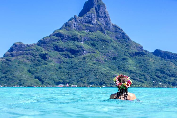woman-in-blue-water-looking-at-mt-otemanu-in-bora